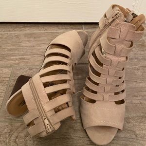 Taupe suede gladiator-style sandals.